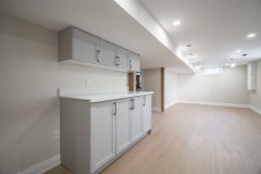 basement-living-space-with-grey-cabinets-1