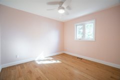 bedroom-with-light-pink-walls-hardwood-floor-and-pot-lights