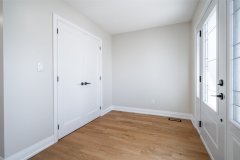 bright-master-bedroom-with-wht-french-door-and-hardwood-floors