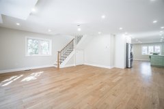 living-room-with-white-walls-hardwood-floor-and-pot-lights