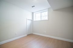 basement-bedroom-with-white-walls-and-hardwood-floor-1536x1024