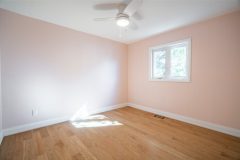 bedroom-with-light-pink-walls-hardwood-floor-and-pot-lights-1536x1024