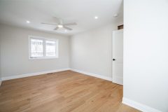 chic-bedroom-with-white-walls-hardwood-floor-and-pot-lights-1536x1024