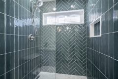 walk-in-shower-design-with-blue-tile-and-chrome-shower-fixtures-1536x1024