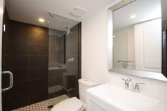 high-end-bathroom-with-glass-shower-and-dark-grey-tile-768x509