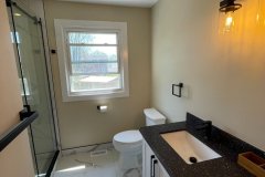 bathroom-with-glass-shower-and-and-marble-tile